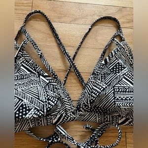 New! Bikini top with light padding and strap details. Ties at neck and back.